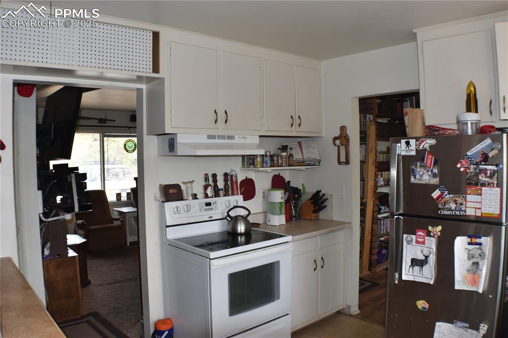 Image 6 of 31: Kitchen featuring white range with electric stovetop, light countertops, wh