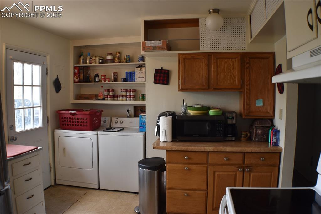Image 7 of 31: Laundry room featuring washing machine and clothes dryer, laundry area, and