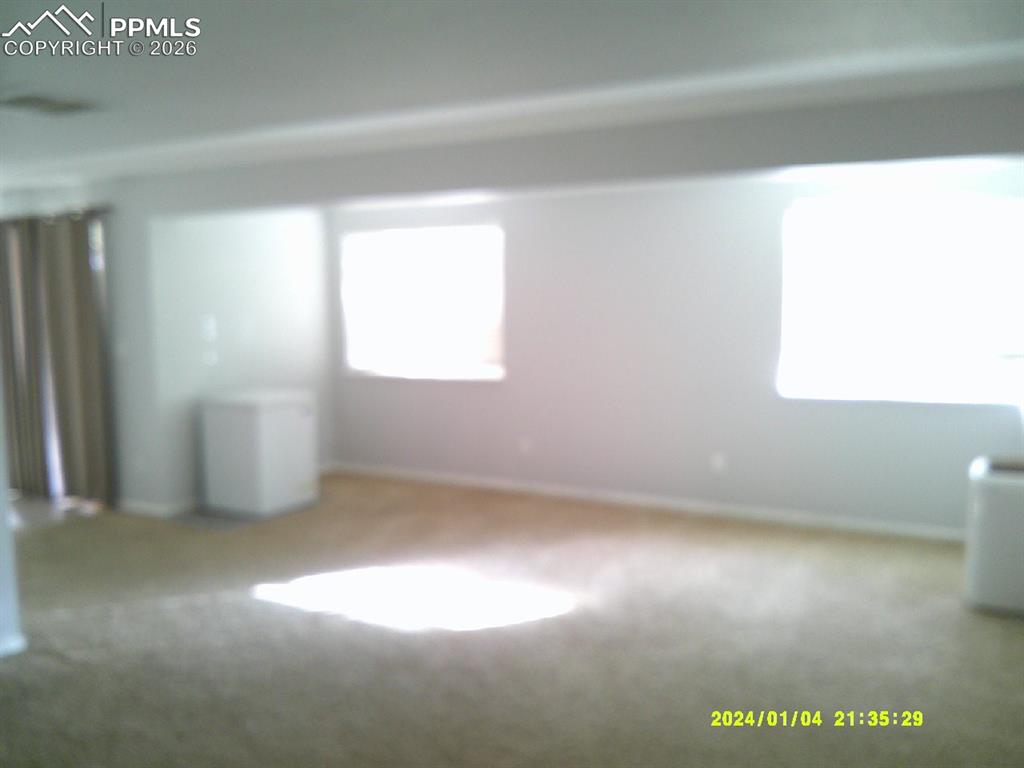 Image 13 of 21: Carpeted spare room with baseboards