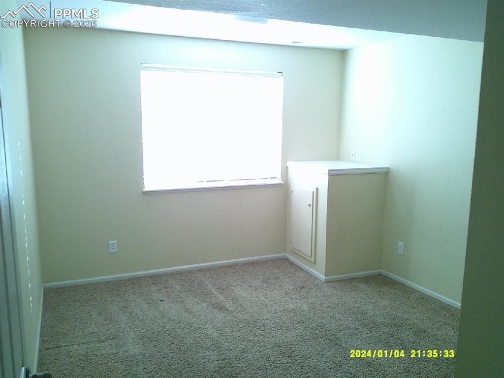 Image 14 of 21: Carpeted spare room featuring baseboards