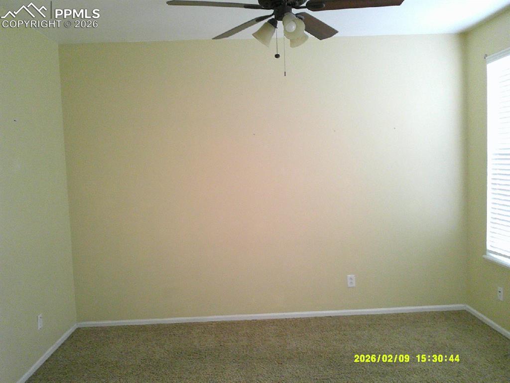 Image 2 of 21: Unfurnished room with carpet and ceiling fan