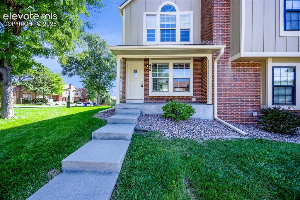 Image 2 of 27: Brick exterior with siding accents, arched transom window, covered front en
