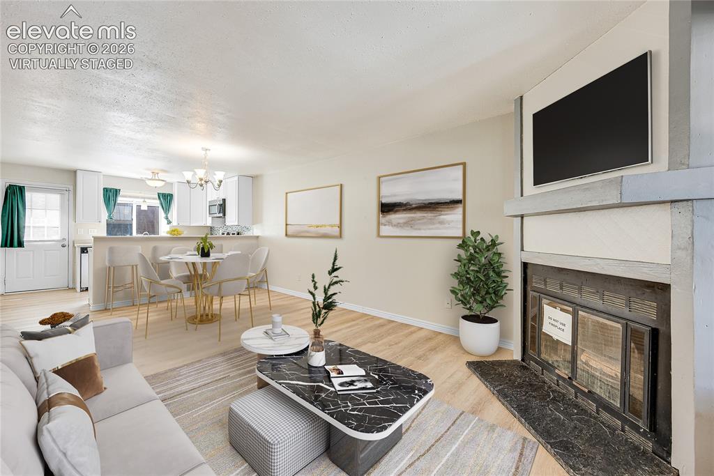 Image 4 of 27: Virtually Staged
Open concept living space featuring wood-finish flooring,