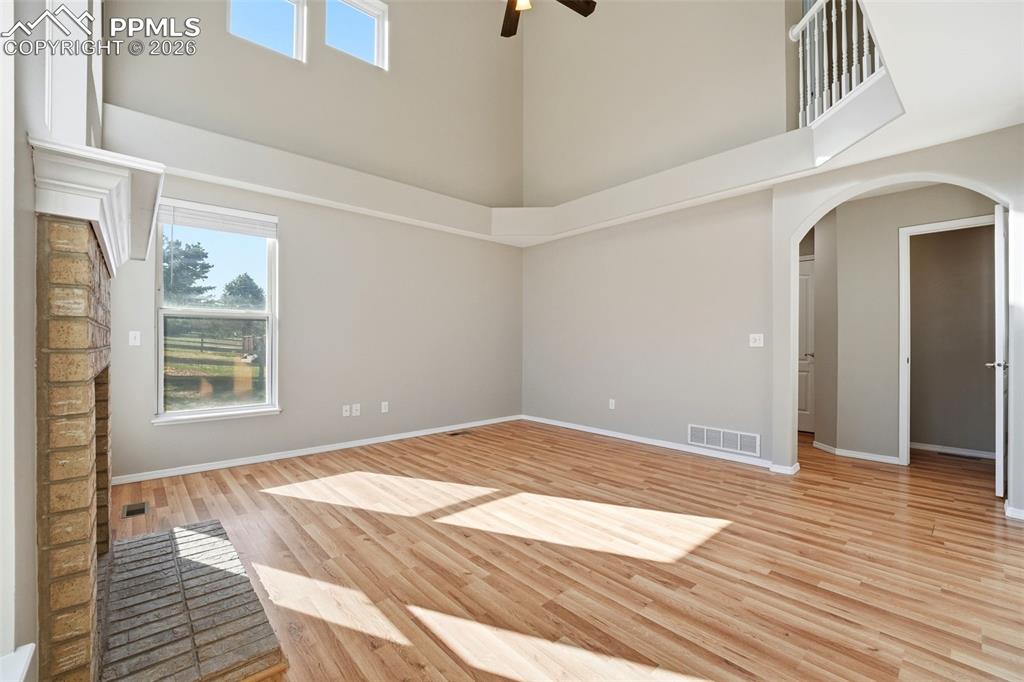 Image 10 of 49: 2-story ceilings with walls of windows and gas fireplace