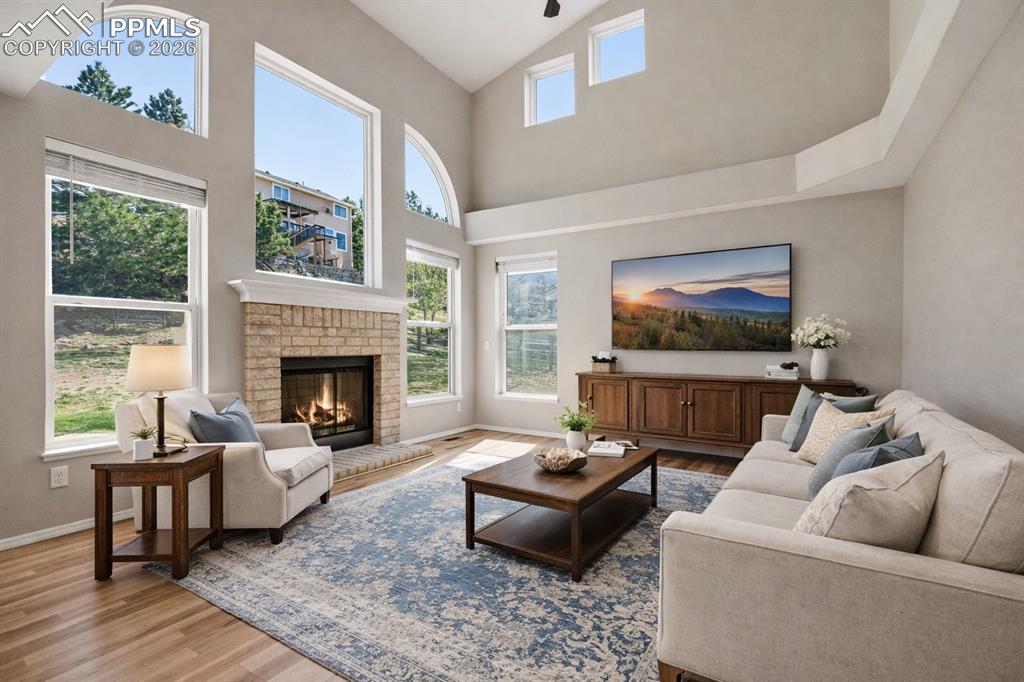Image 11 of 49: 2-story ceilings with walls of windows and gas fireplace