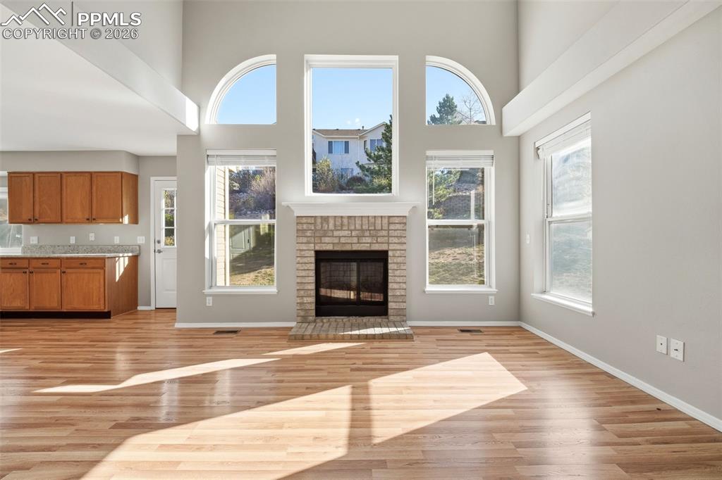 Image 14 of 49: 2-story ceilings with walls of windows and gas fireplace