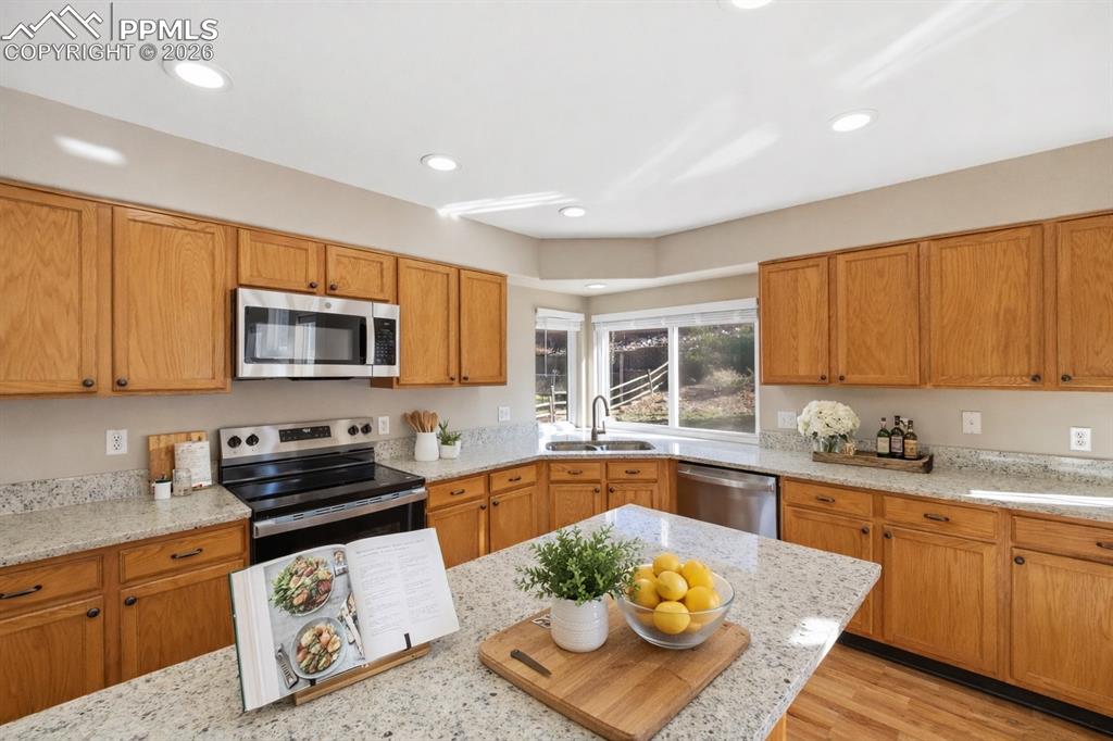Image 18 of 49: Granite counters and stainless steel appliances