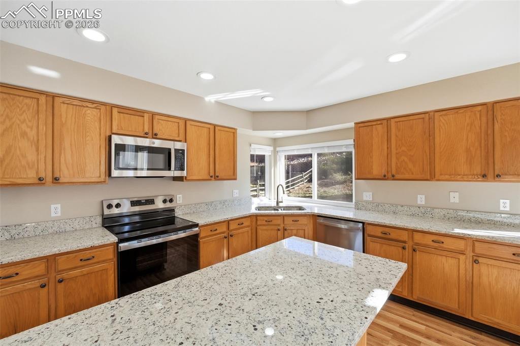 Image 19 of 49: Granite counters and stainless steel appliances