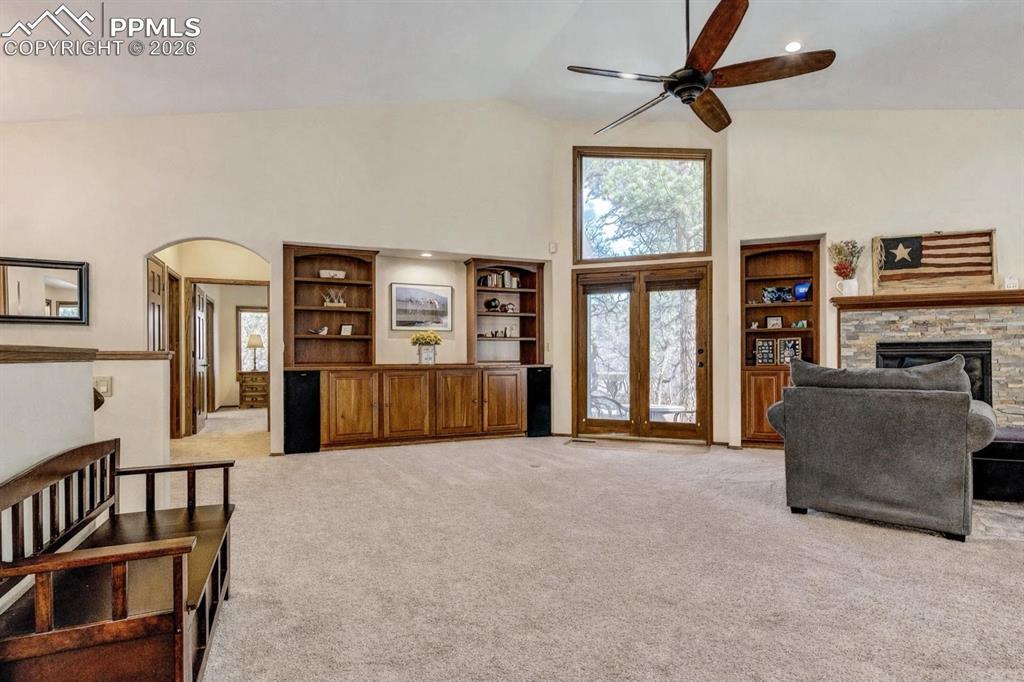 Image 10 of 48: This is the same room without as much furniture. Living area featuring a fi