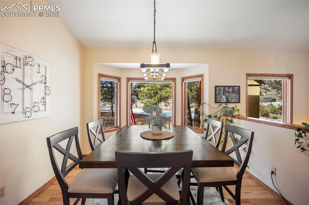 Image 16 of 48: Dining space featuring hardwood floors and a chandelier
