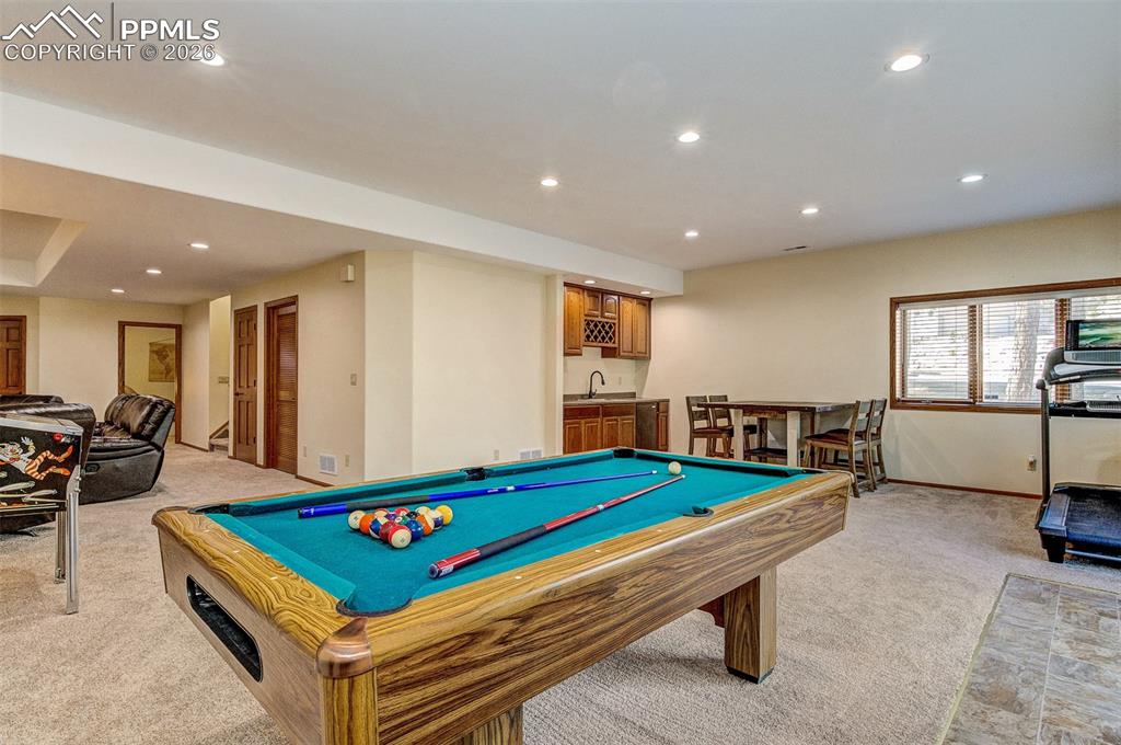 Image 29 of 48: Game room featuring light colored carpet, billiards, recessed lighting, and