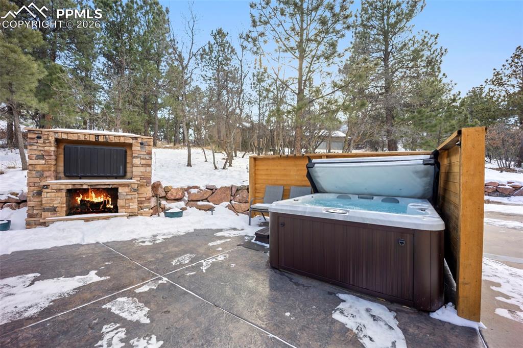 Image 35 of 48: Large entertaining space and patio with a patio, water feature, a hot tub, 