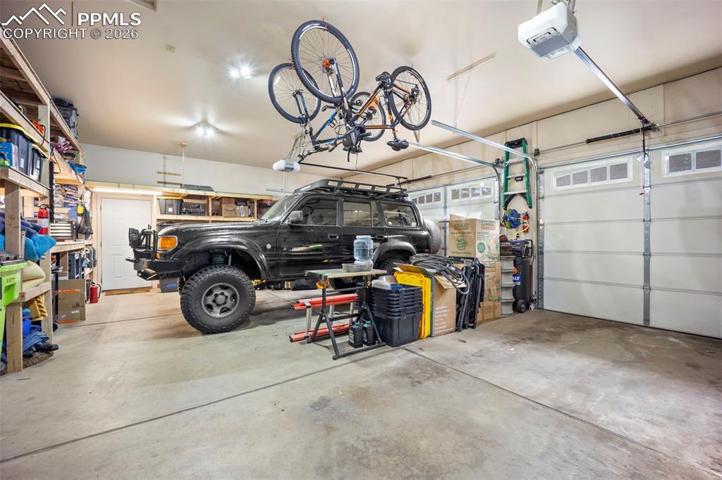 Image 46 of 48: Garage featuring a garage door opener