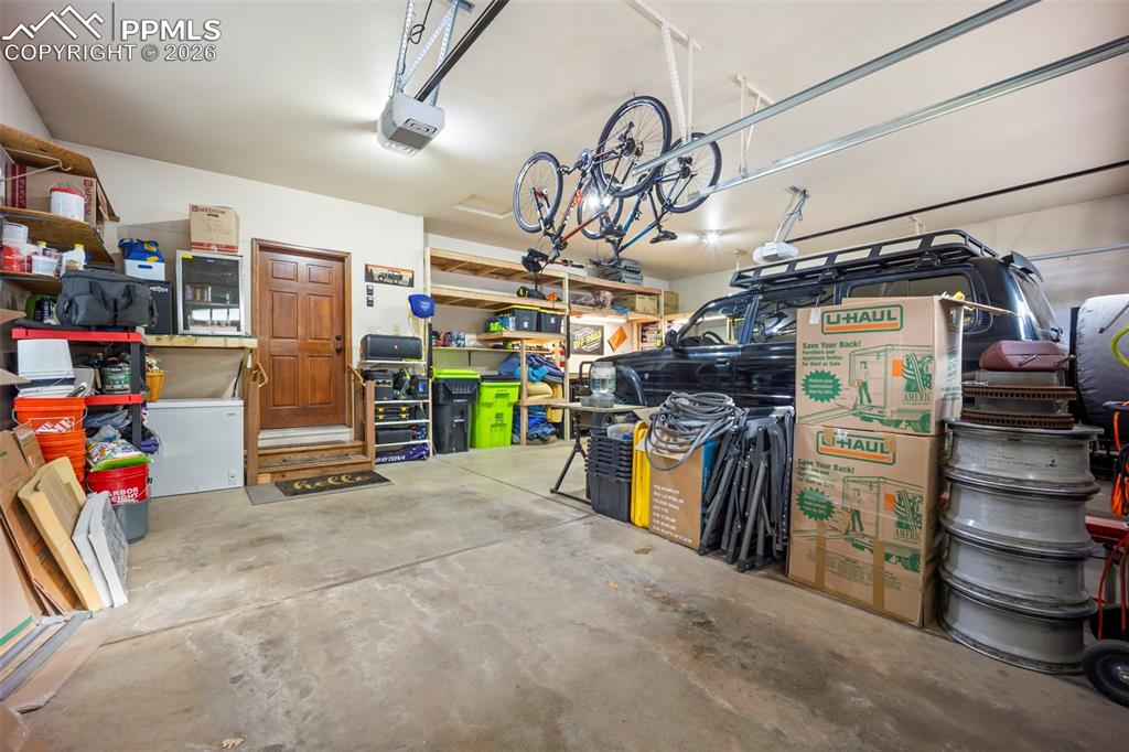 Image 47 of 48: Garage featuring a garage door opener