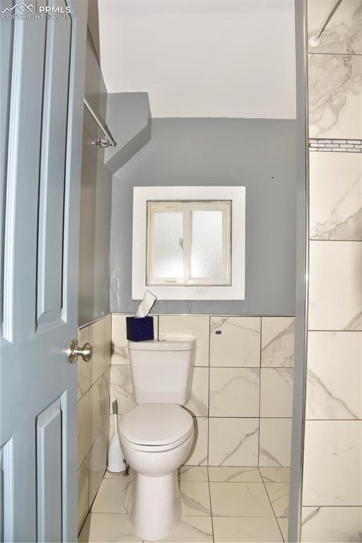 Image 17 of 46: Bathroom featuring toilet and marble finish floors
