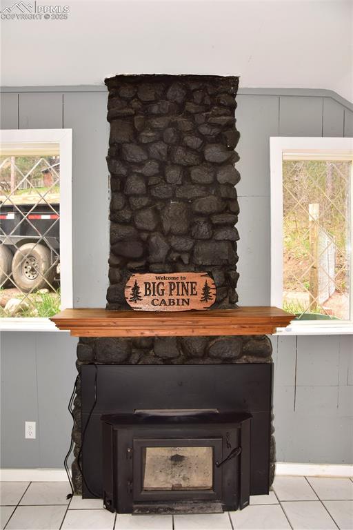 Image 3 of 46: Detailed view of a wood stove and a decorative wall