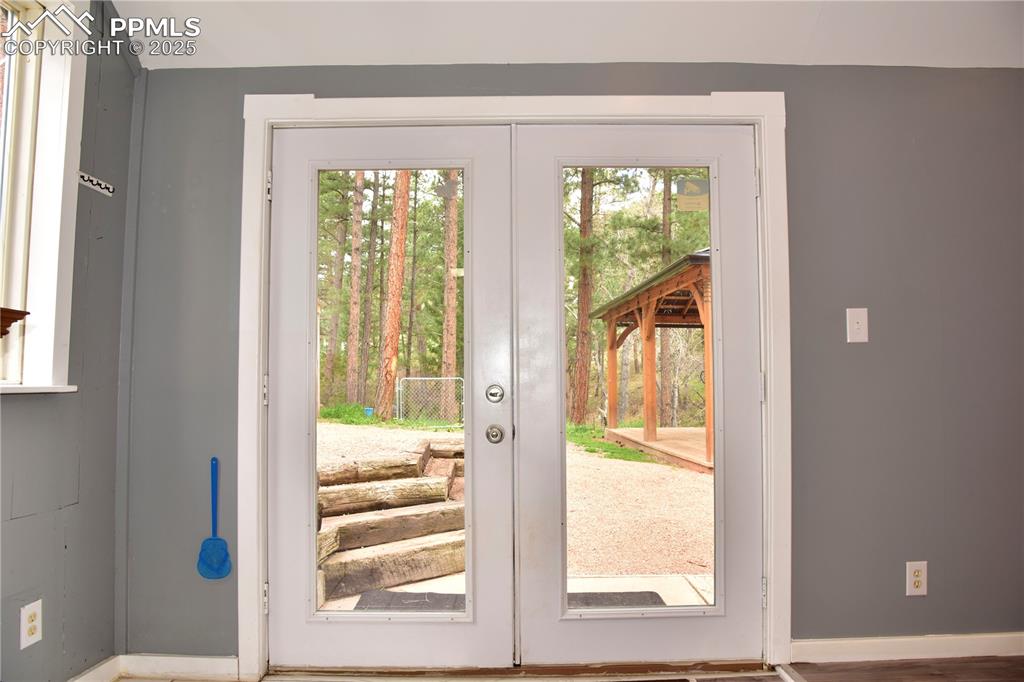 Image 4 of 46: Doorway to outside featuring french doors and baseboards