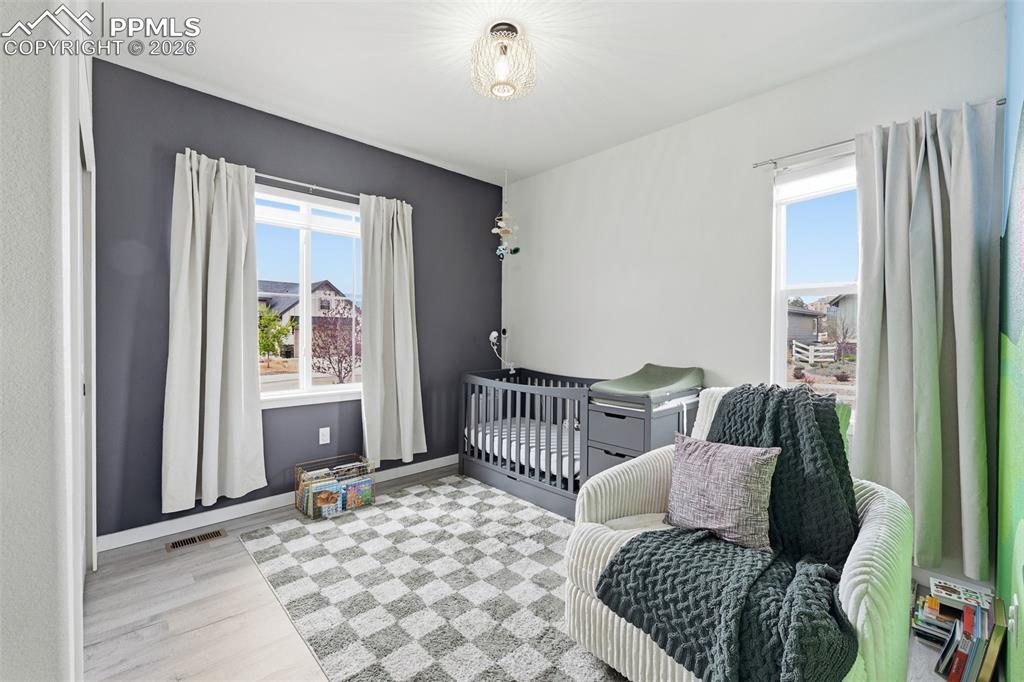Image 16 of 47: Secondary main level bedroom with tall ceilings