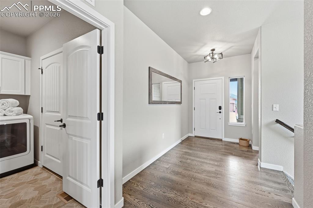 Image 20 of 47: Large entryway with real wood floors