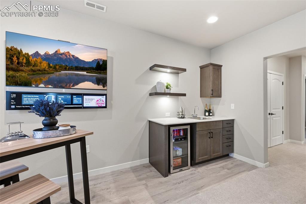Image 24 of 47: Walk-up wet bar with upgraded cabinets and quartz countertops
