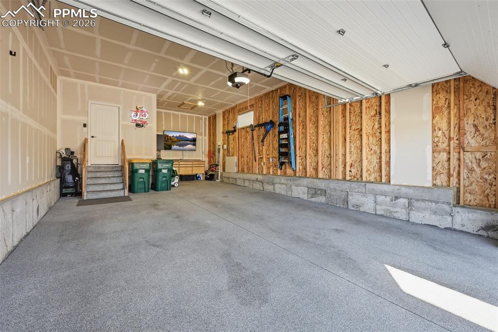 Image 34 of 47: Stunning garage with 3rd car tandem