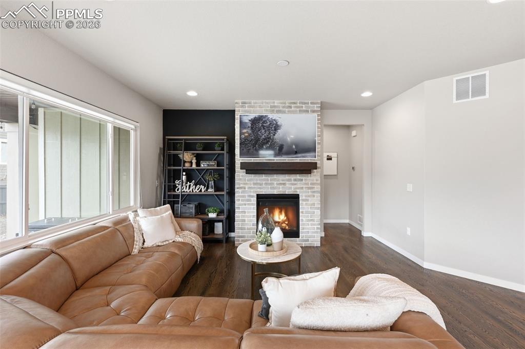 Image 7 of 47: Large living room with brick fireplace