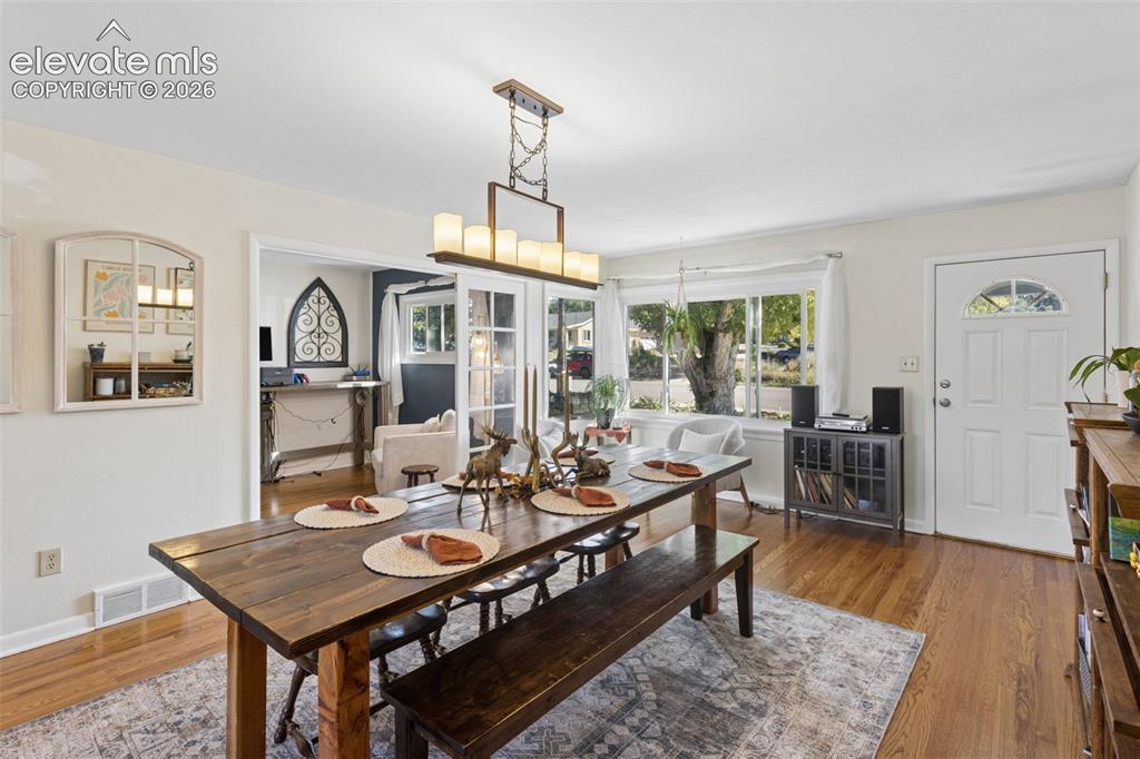 Image 10 of 50: Hardwood flooring throughout, recessed lighting, and a white paneled entry 