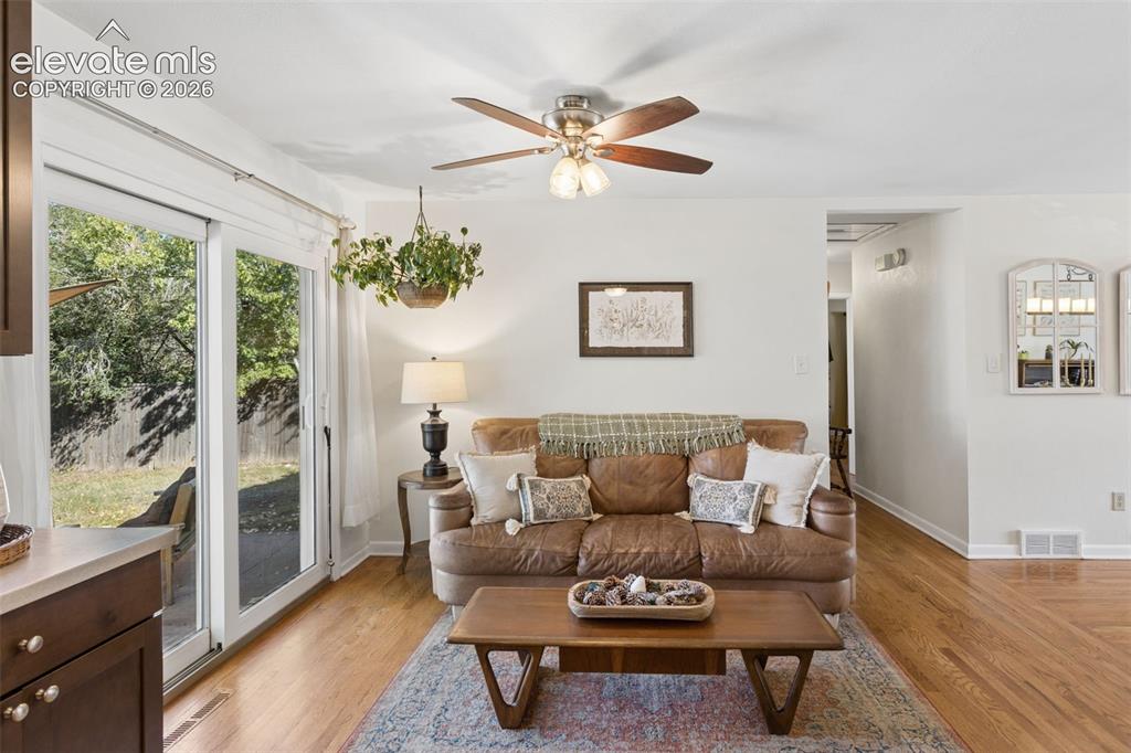 Image 16 of 50: Hardwood flooring throughout, recessed lighting, and a ceiling fan