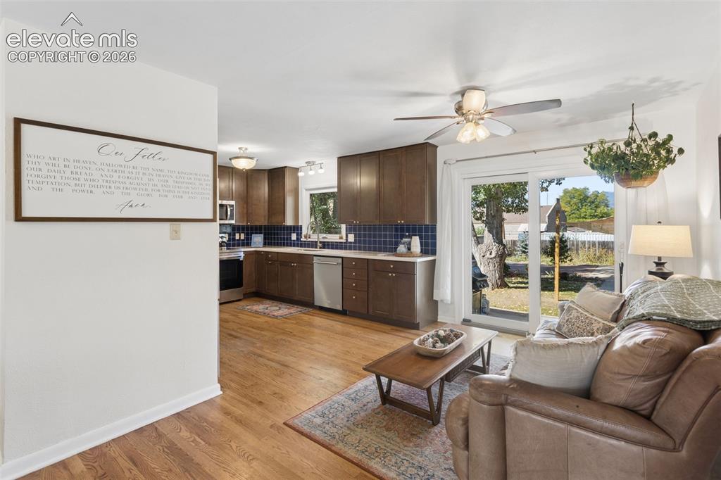 Image 17 of 50: Hardwood-finish flooring throughout, kitchen with dark wood cabinetry and t