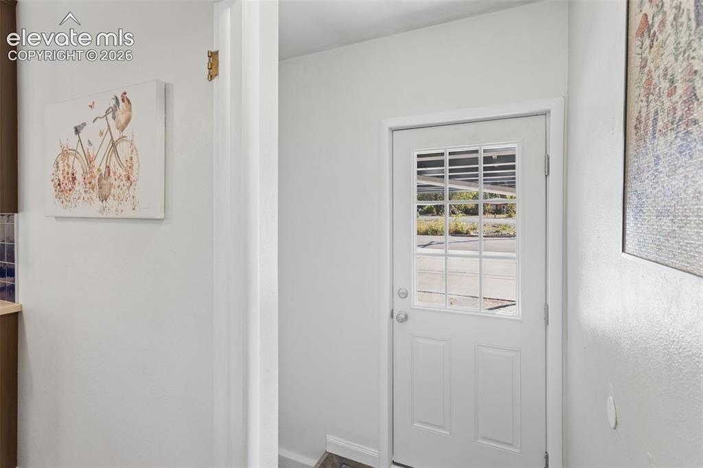 Image 21 of 50: White paneled door with divided lite window