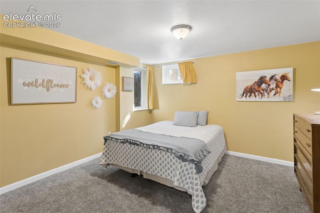 Image 27 of 50: Carpeted flooring, recessed window, and overhead flush mount lighting