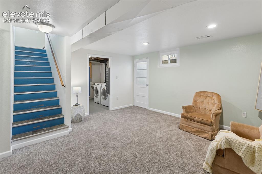 Image 30 of 50: Carpeted flooring, recessed lighting, white trim, and a window.  Basement D