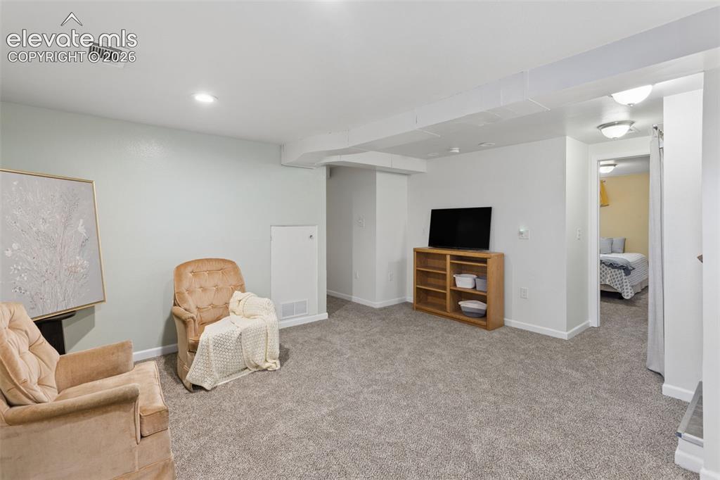Image 31 of 50: Light gray wall paint, recessed lighting, carpet flooring, baseboard heatin