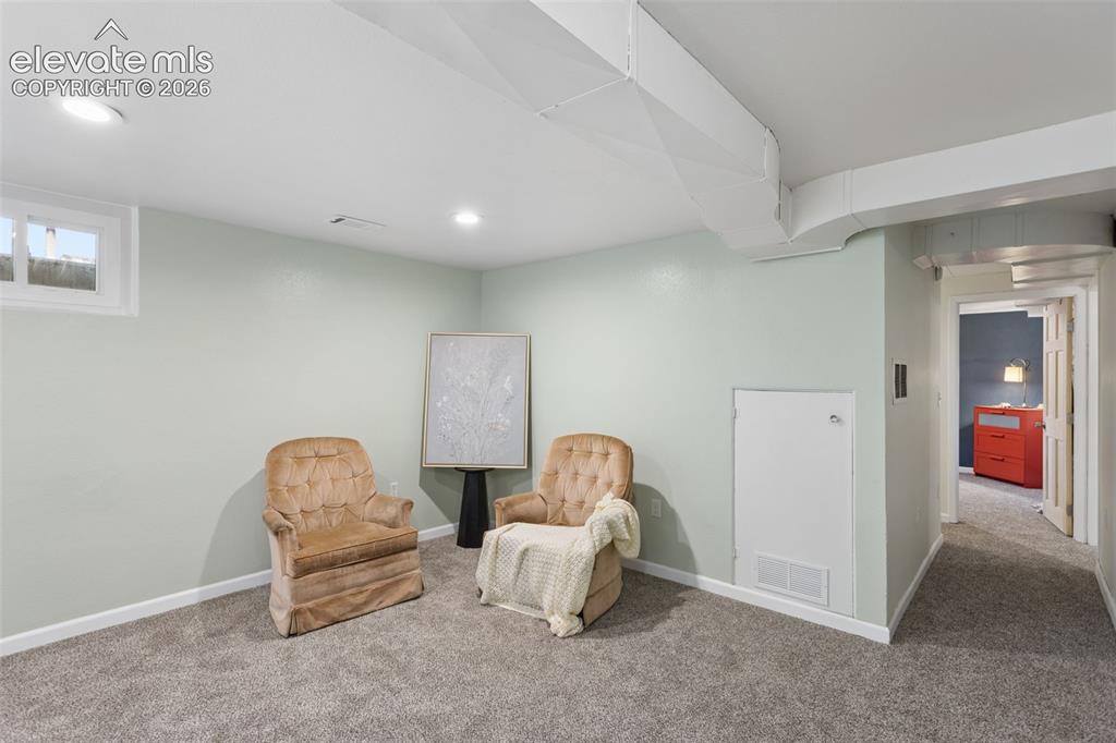 Image 32 of 50: Recessed ceiling lighting, white trim, light-toned walls, and grey carpet