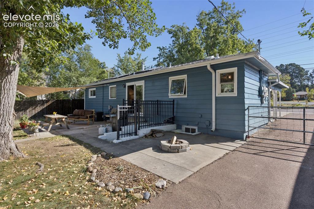 Image 45 of 50: Blue siding exterior with white trim windows and a white gutter system