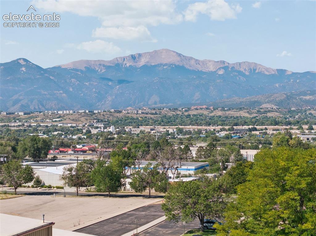 Image 5 of 50: Mountain backdrop with a distant urban landscape