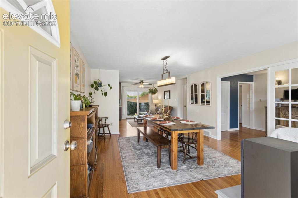 Image 8 of 50: Hardwood flooring throughout, recessed lighting, and a modern dining chande
