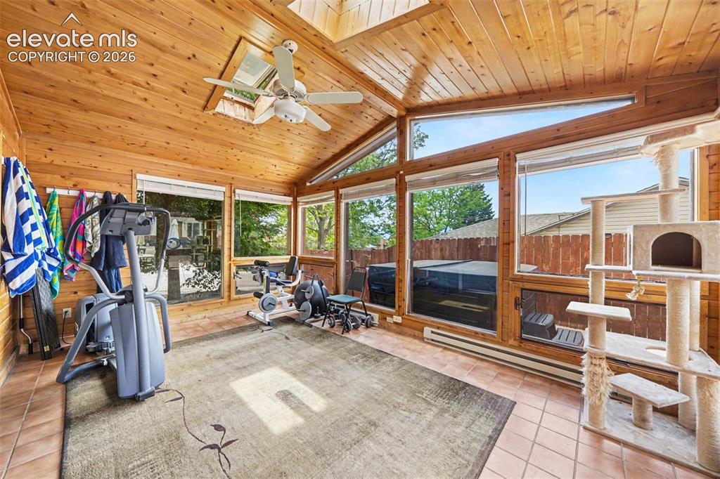 Image 24 of 31: Huge Heated Sunroom with skylights. Perfect for Guests preparing for the ou