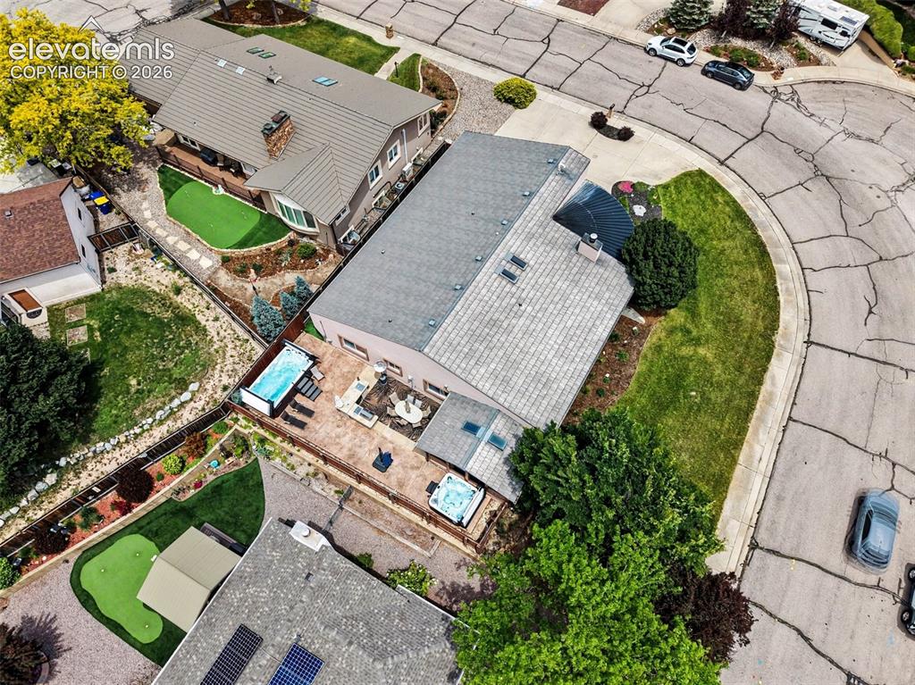 Image 29 of 31: Private fully fenced backyard featuring patio entertainment areas, hot tub,
