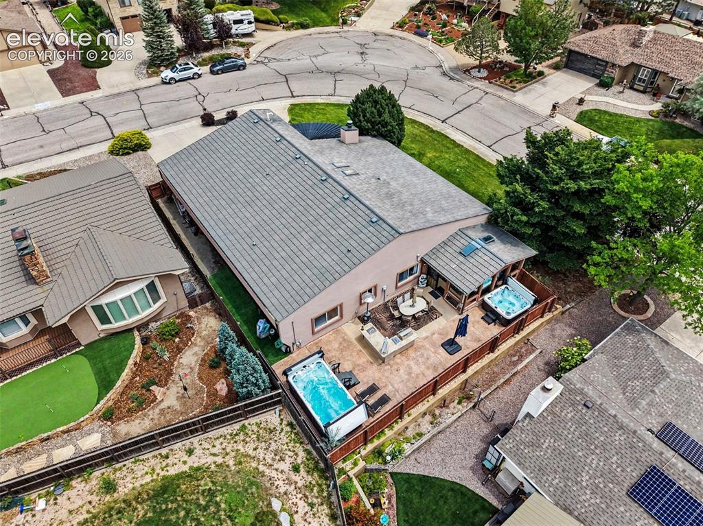 Image 30 of 31: Expansive outdoor living area featuring a built-in spa, additional swim spa