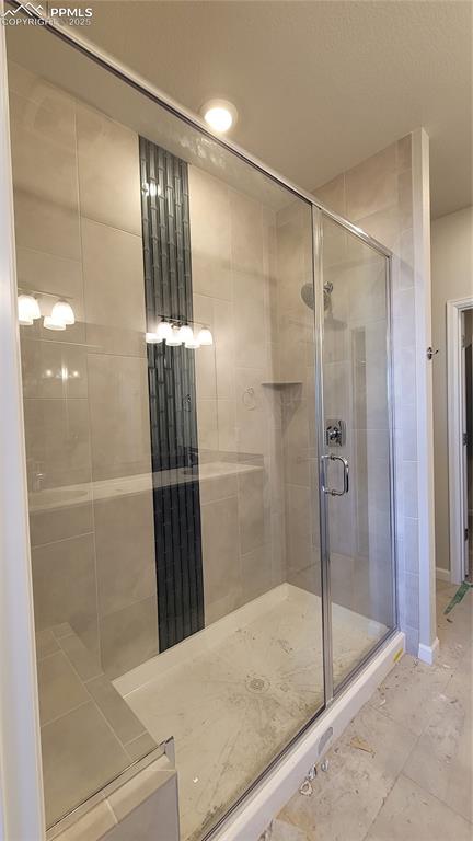 Image 17 of 36: Primary Shower with bench and tile surrounds! Please, excuse our dust as th