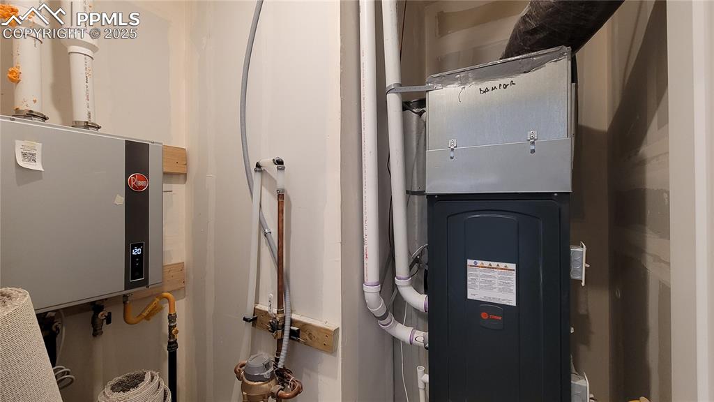 Image 29 of 36: Utility Closet, conveniently located on the main level with a tankless wate