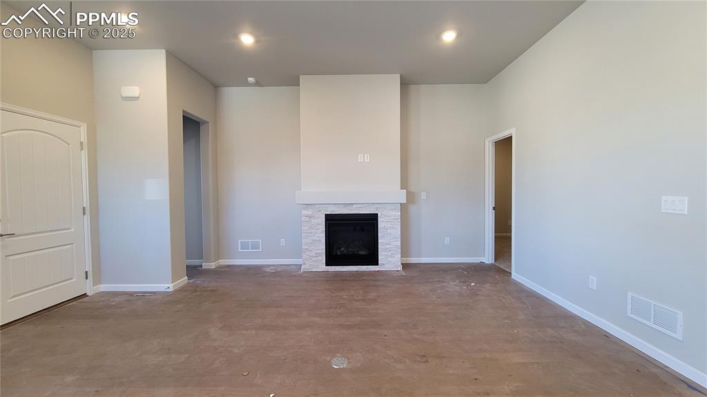 Image 8 of 36: Living Room with engineered wood flooring, floor outlet, gas fireplace with