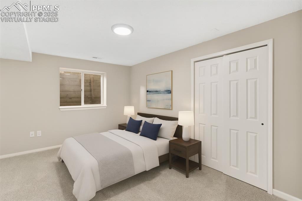 Image 21 of 32: Basement bedroom, virtually staged.