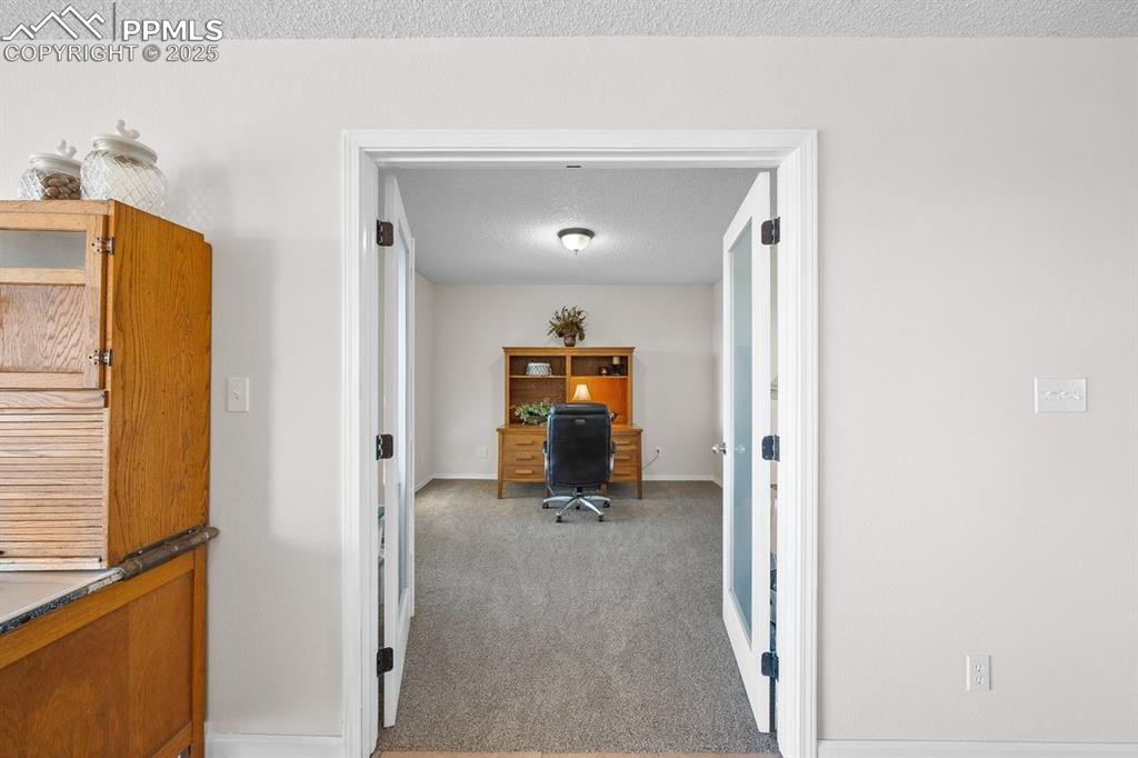 Image 19 of 39: Office area featuring light colored carpet 