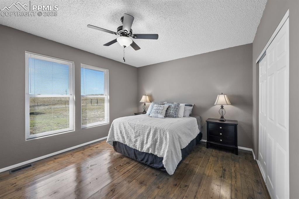 Image 21 of 39: Bedroom featuring dark wood floors, a closet and ceiling fan