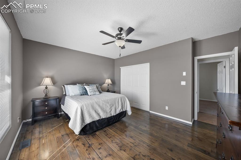 Image 22 of 39: Bedroom featuring dark wood floors, a closet and ceiling fan