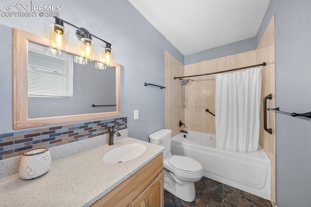 Image 23 of 39: Bathroom featuring shower / tub combo,  with jetted and heated tub, vanity,