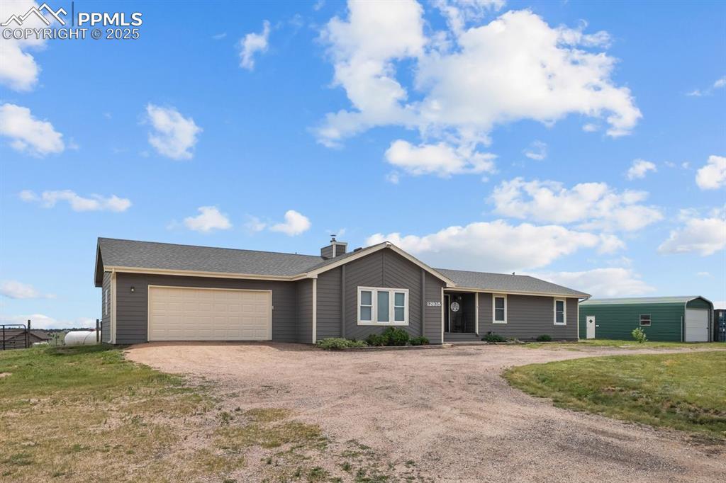 Image 29 of 39: Ranch-style home featuring dirt circular driveway