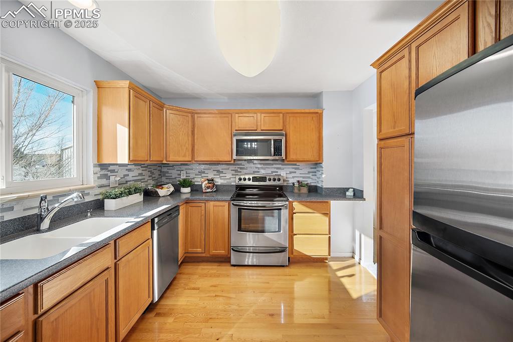 Image 12 of 48: Updated kitchen with stainless steel applainces, corian countertops and har